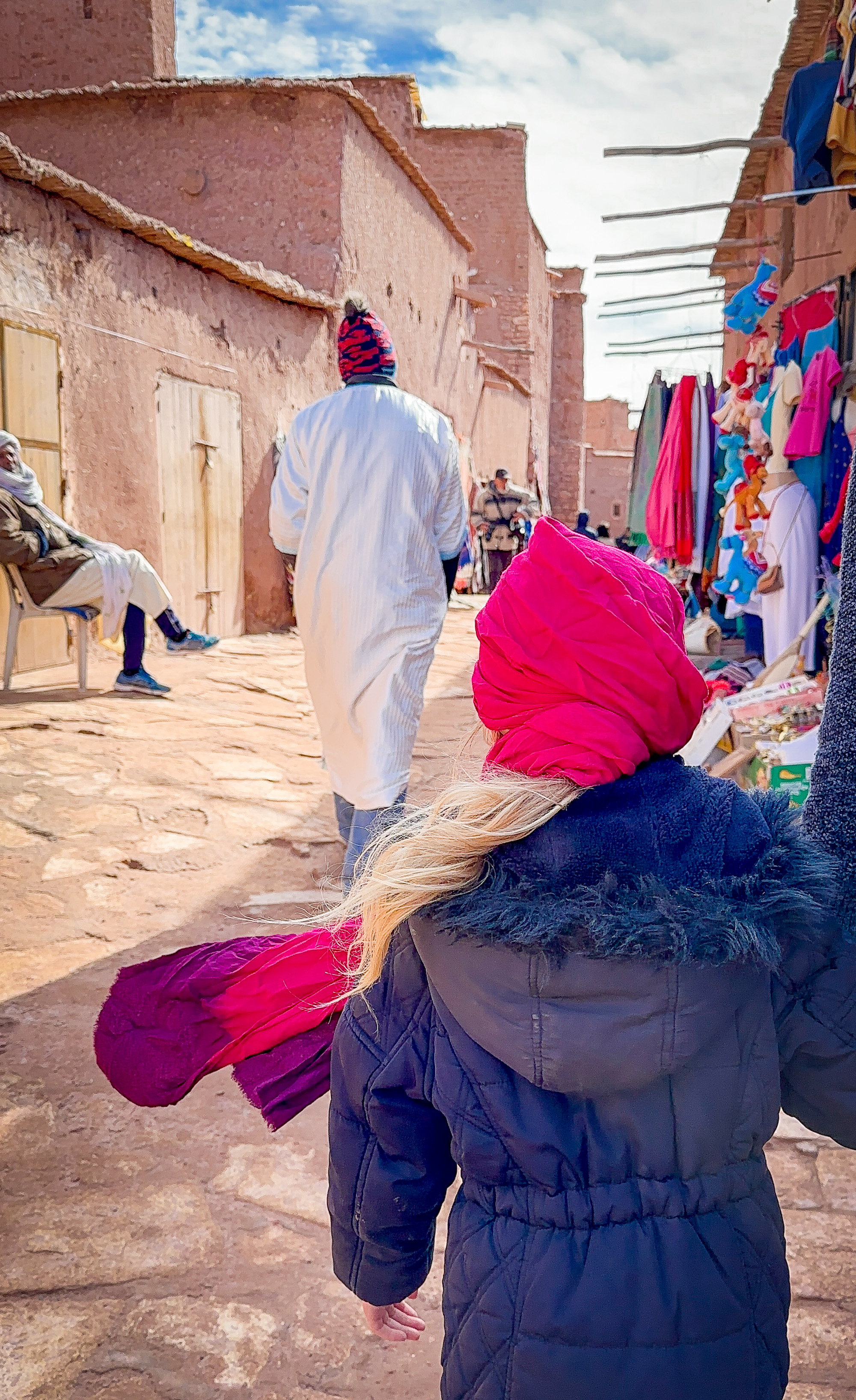 A child follows a Berber guide through the alleyways of UNESCO World Heritage Site Ait Benhaddou