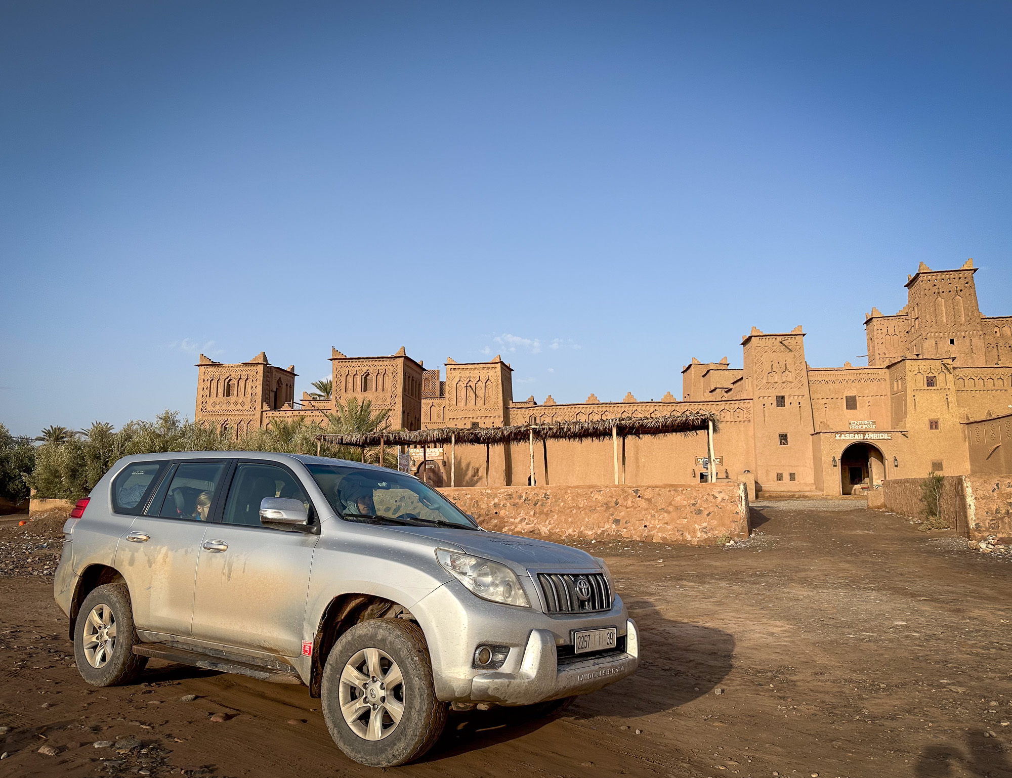 Morocco-Skoura-Moroccan-road-trip-with-car-and-Berber-driver-outside-Kasbah-Amridil with car on a Moroccan road trip