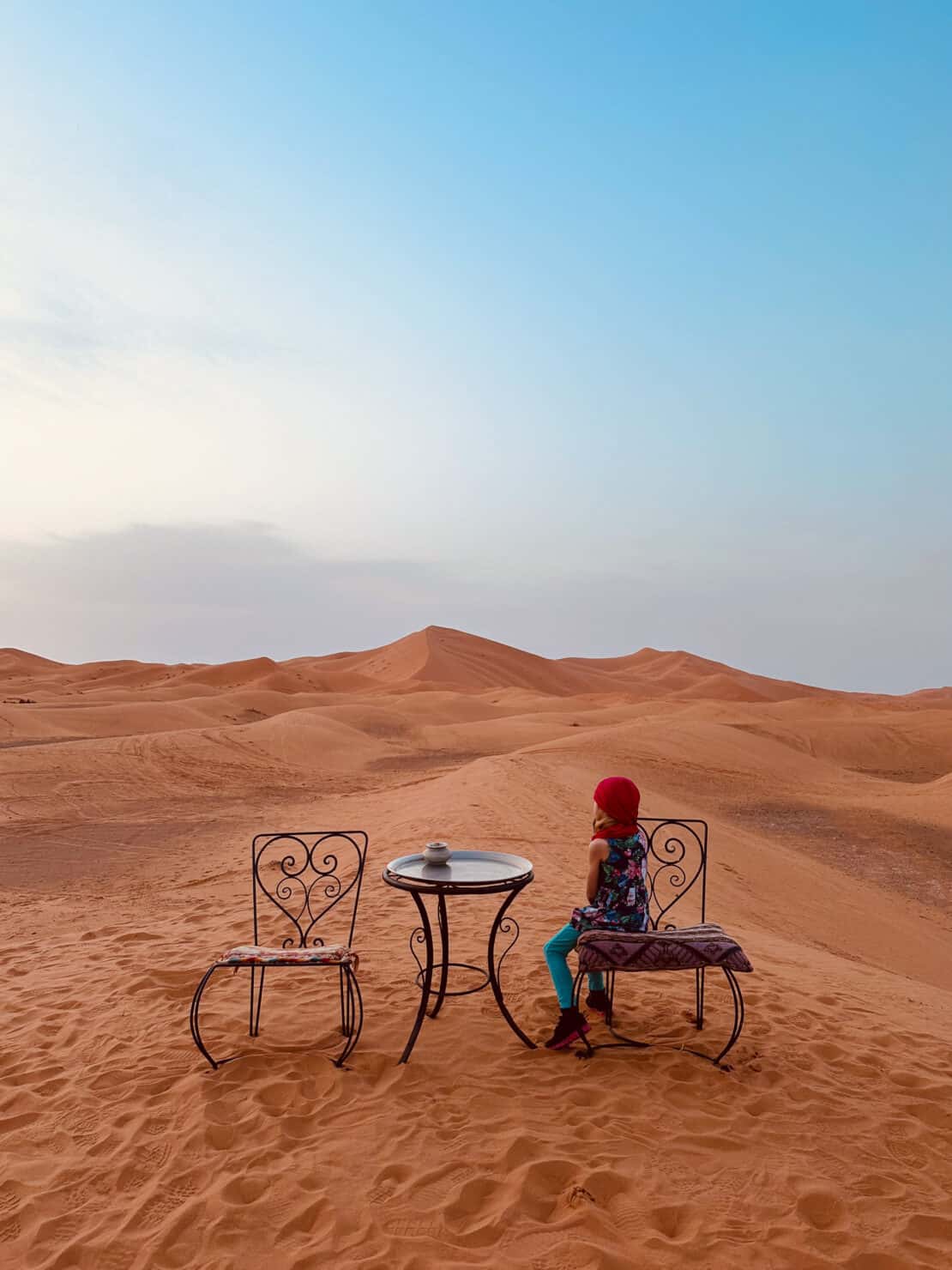 Child staring out at the sand dunes in Morocco