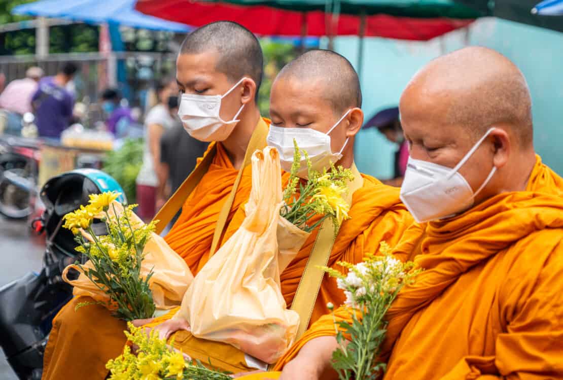 Thai monks with alms in the city of Nan Thailand