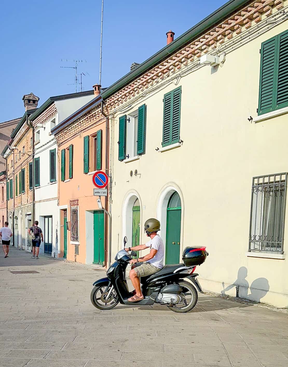 Street scene of Comacchio Italy with a man on a motorbike