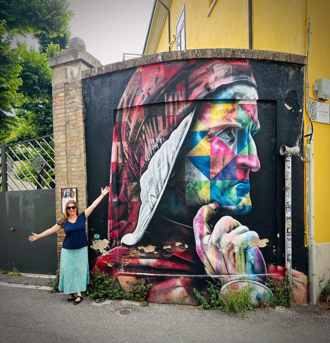 Abigail King standing by Dante Street Art in Ravenna, Italy