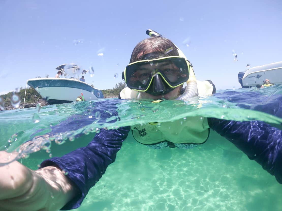 Abigail King snorkelling in the Caribbean with a ship in the background