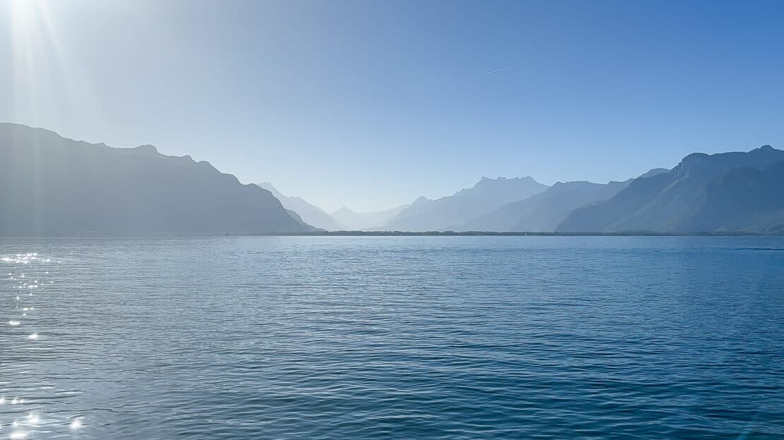 Lake Geneva view with silhouetted mountains in the distance