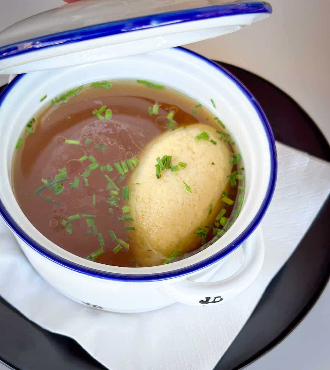 Semolina dumpling in a broth soup in a white dish in Austria