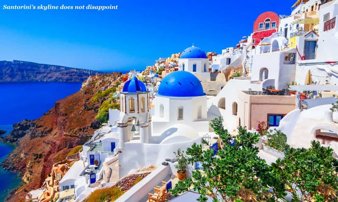 Iconic white houses in Santorini perched on a cliff top 