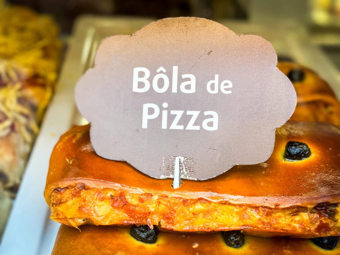 Bola de pizza slice with sign - a variation of Bola de Lamego
