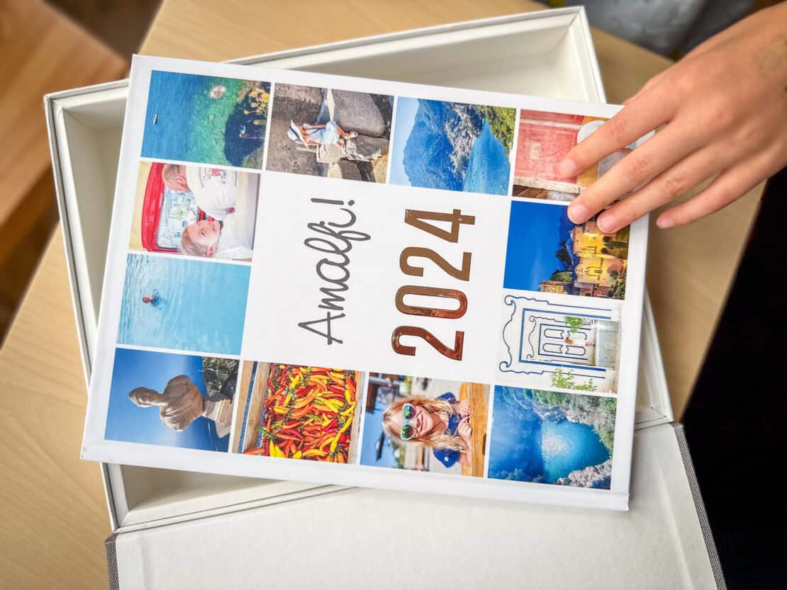 travel photo book in box with hand