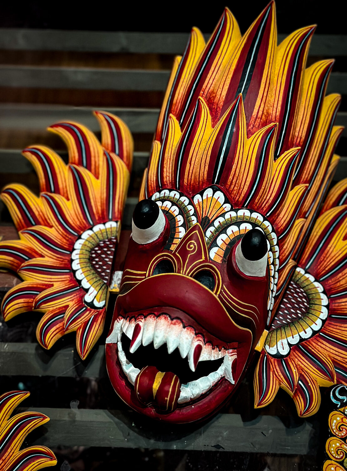 Close up of flaming traditional Sri Lankan Mask with tongue out - copyright Abigail King