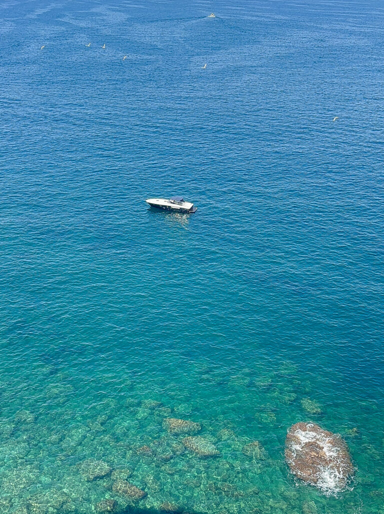 Italy - Amalfi Coast - boat in serene blue sea
