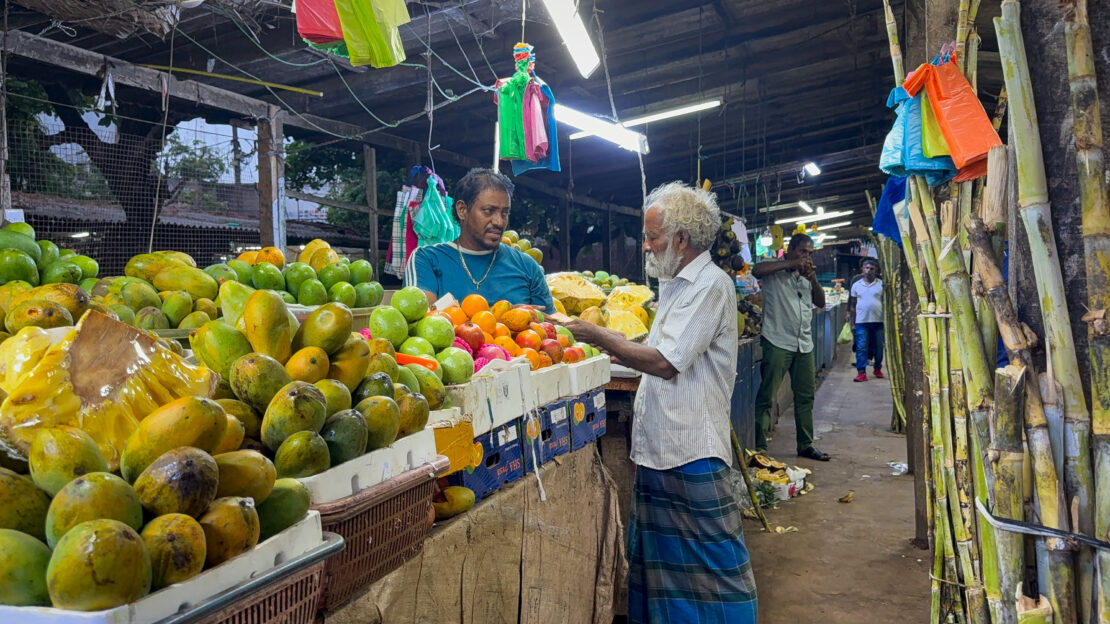 Man shops for fruit at Jaffna Market in Sri Lanka - things to do in Jaffna