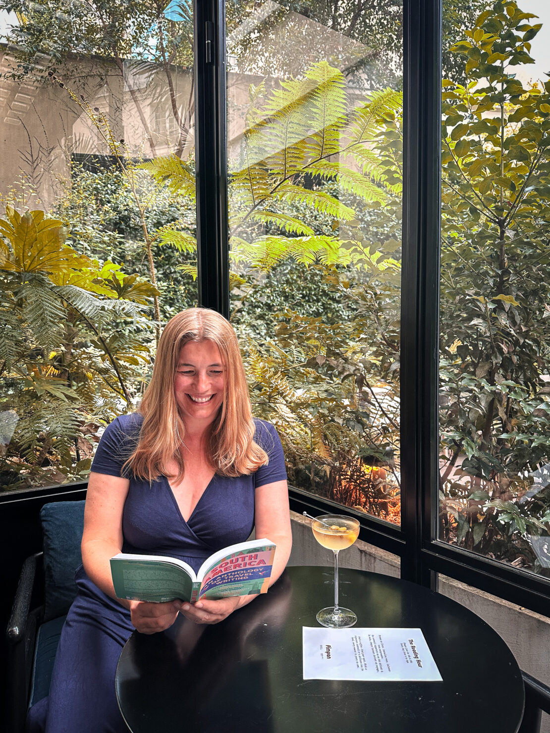 Abigail King reading a book at the Reading Hour at Hôtel Dame des Arts in Paris -  best things to do in the Latin Quarter, Paris 