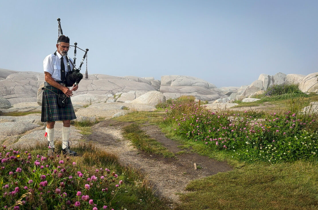 Man playing bagpipes at Peggy's Cove Nova Scotia Canada