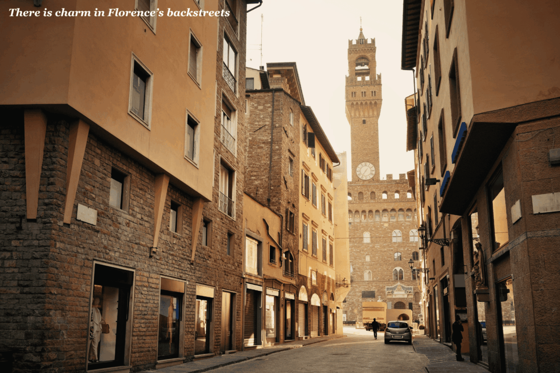 Backstreet of Florence with a view of a clock tower - trip to Tuscany