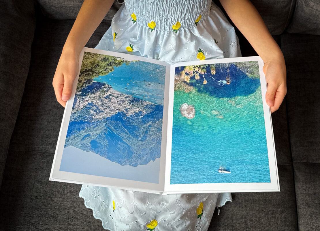 Girl with Amalfi coast travel photo book