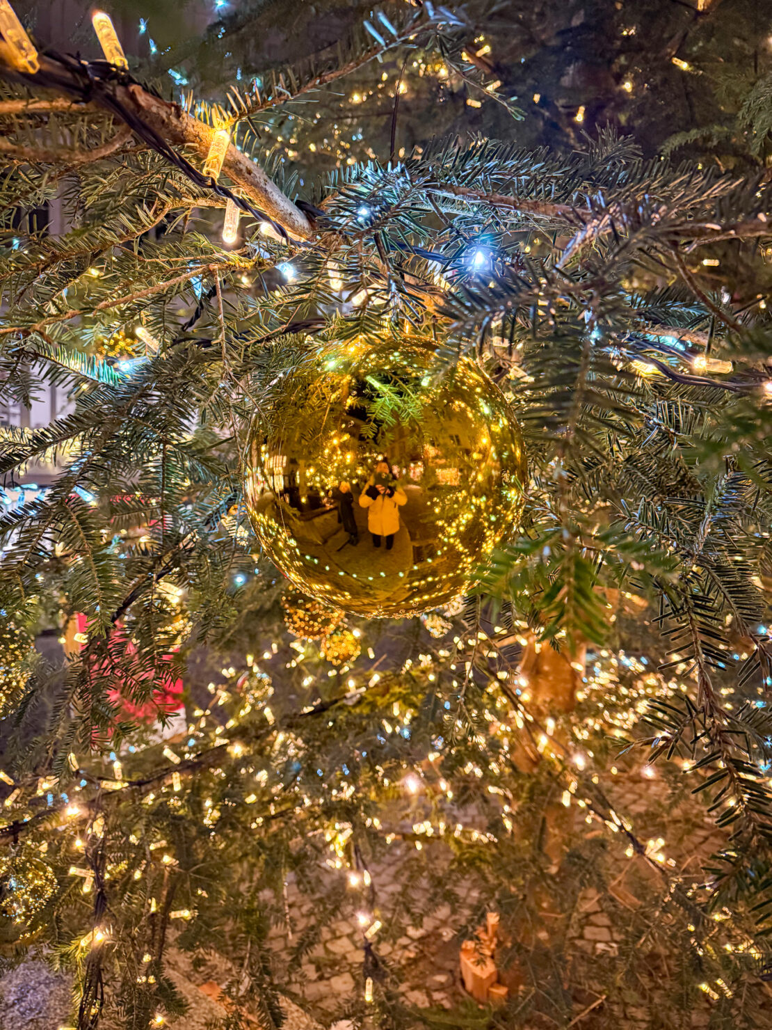 Abigail King reflected in a bauble in Switzerland