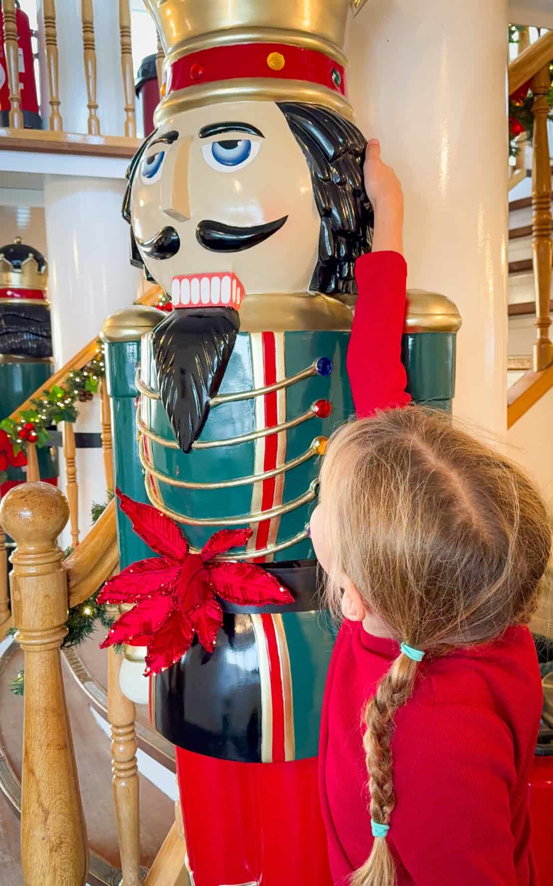 Child reaching for nutcracker wearing long sleeved thermal