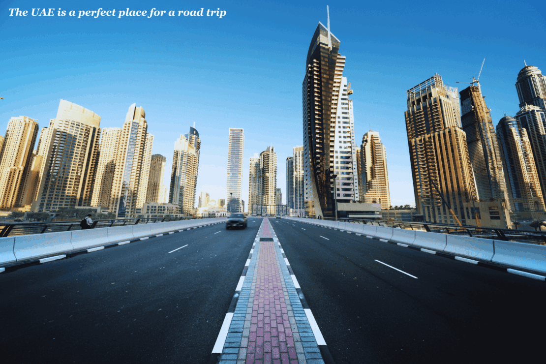 Car driving through the skyscrapers in Dubai, UAE