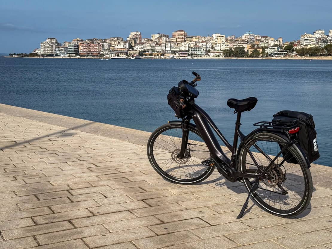 Bike parked by the water in Sarandë in Albania - cycling in Albania