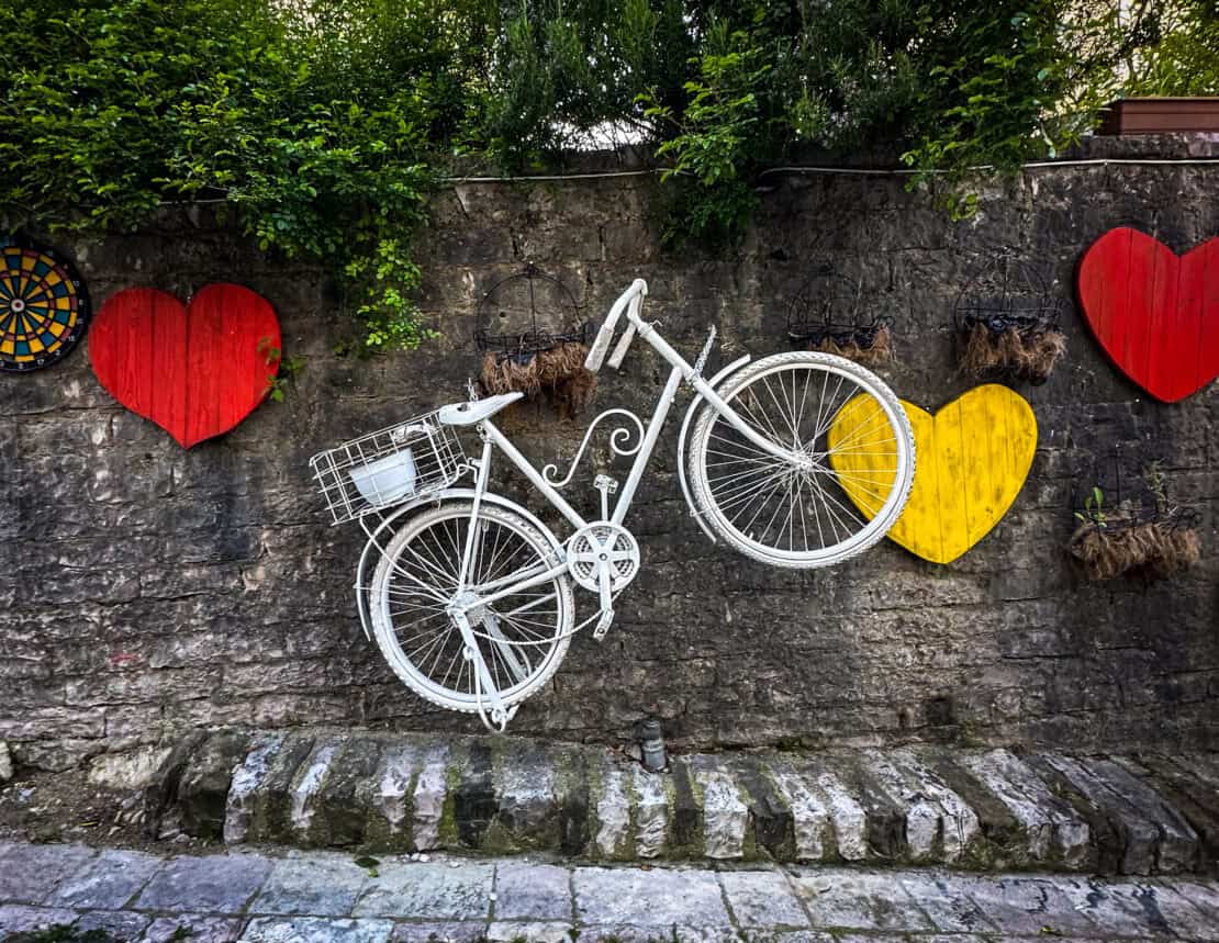 White bicycle art on wall in Gjirokaster, Albania - cycling in Albania