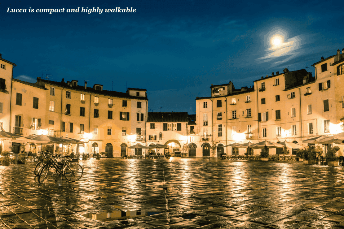 Buildings lit up at night in amphitheatre square in Lucca, Italy - Florence or Lucca?