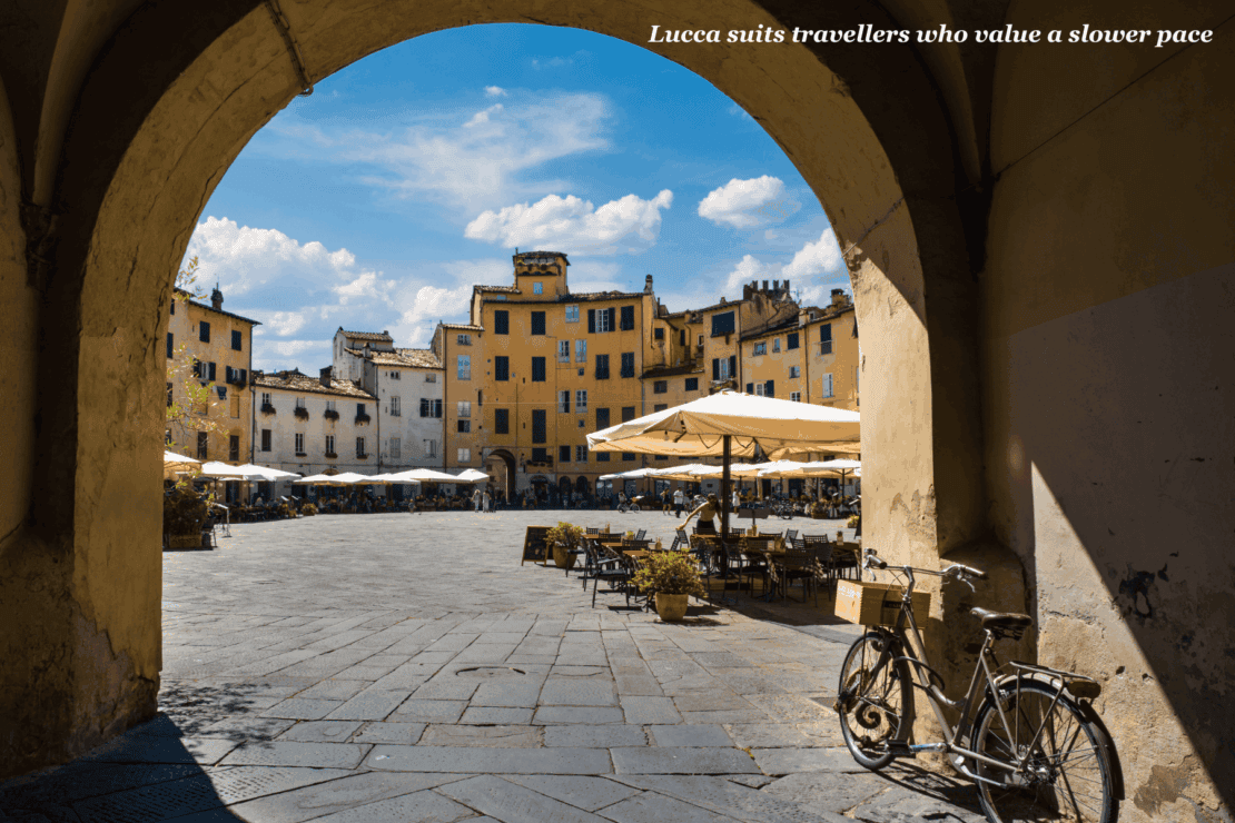 Bicycle under the arched entrance to the main square in Lucca, Italy - Florence or Lucca?