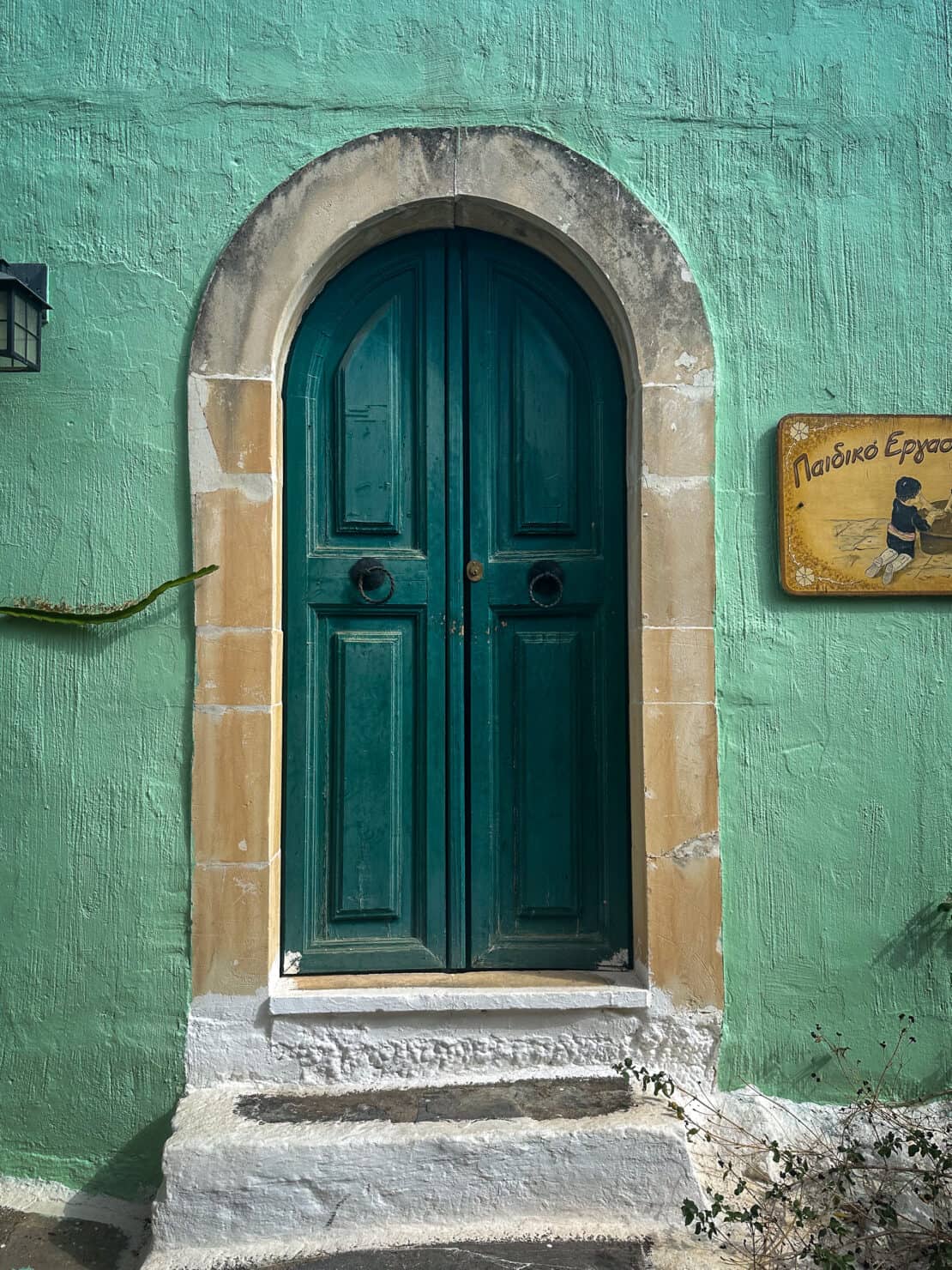 Traditional green door in museum village in Crete, Greece
