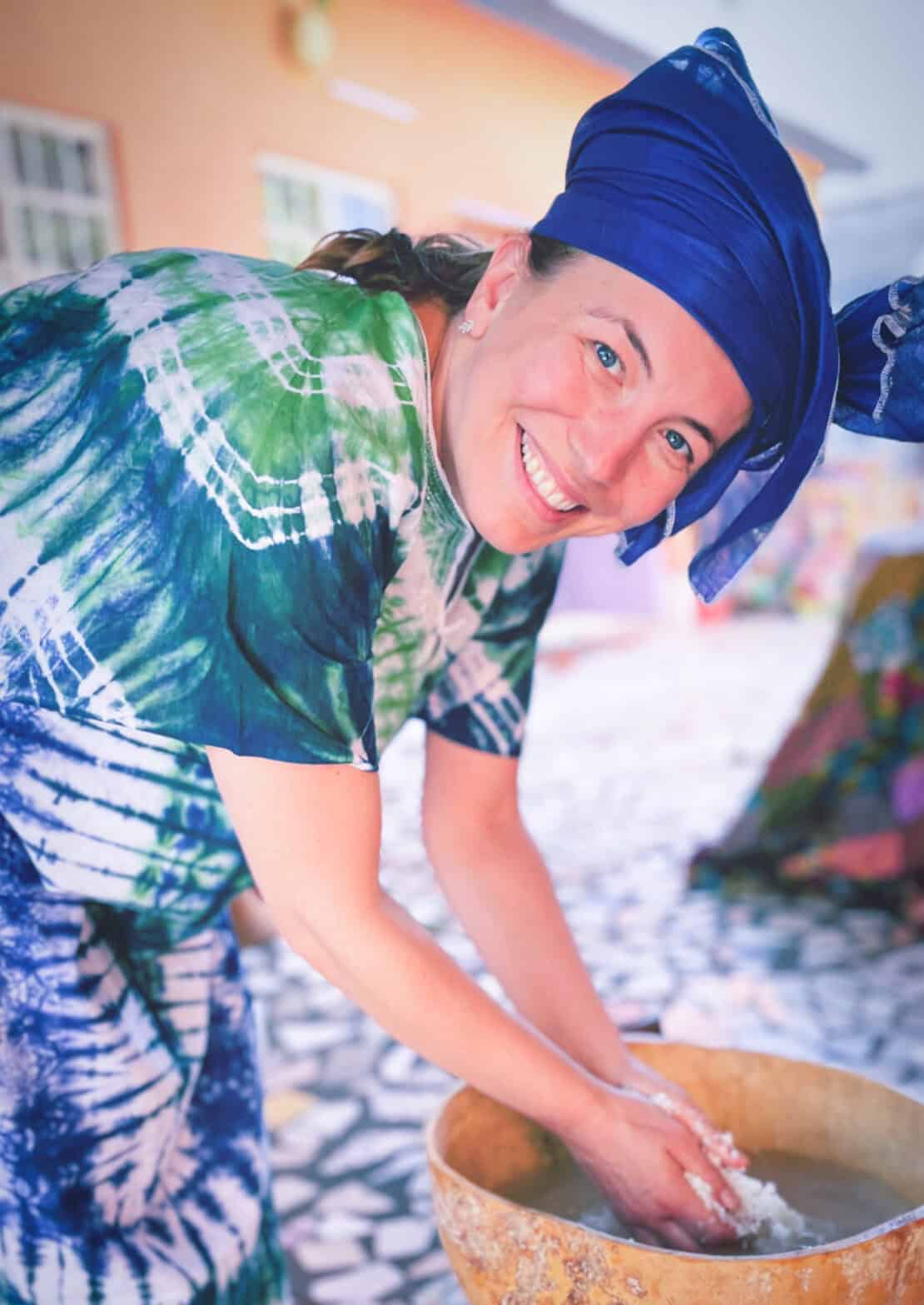Abigail King washing hands in traditional dress in The Gambia