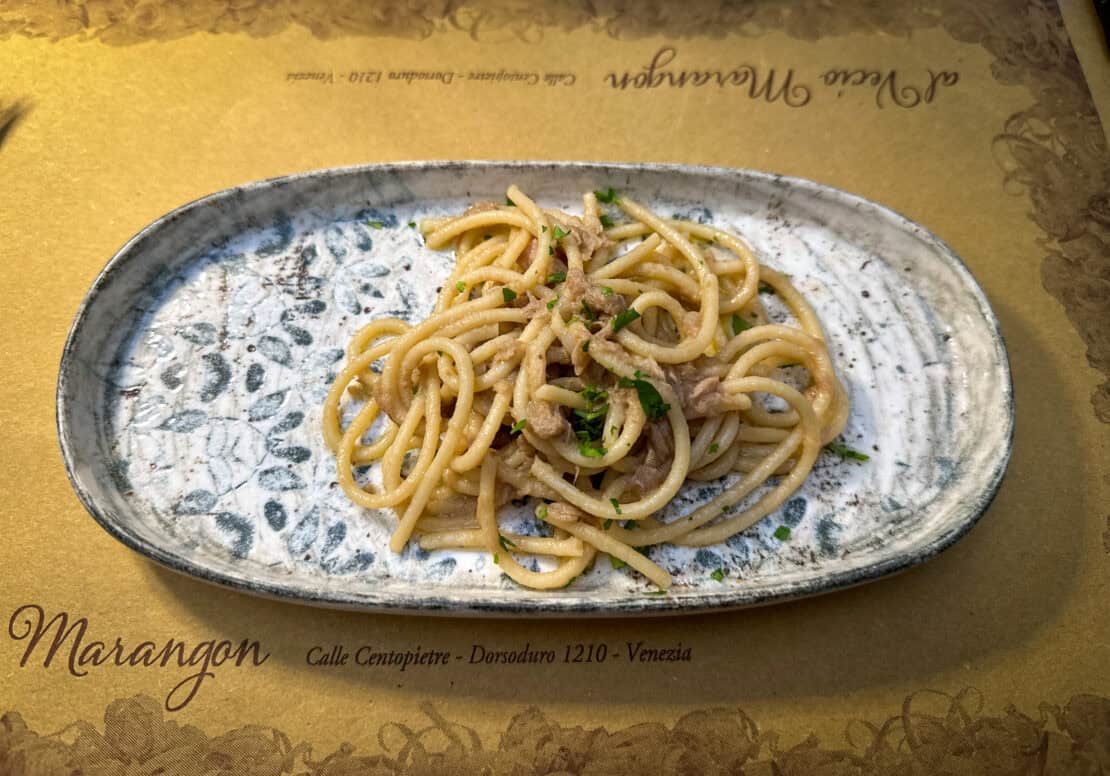 Traditional bigoli in salsa pasta with anchovies and onions served in Venice, Italy