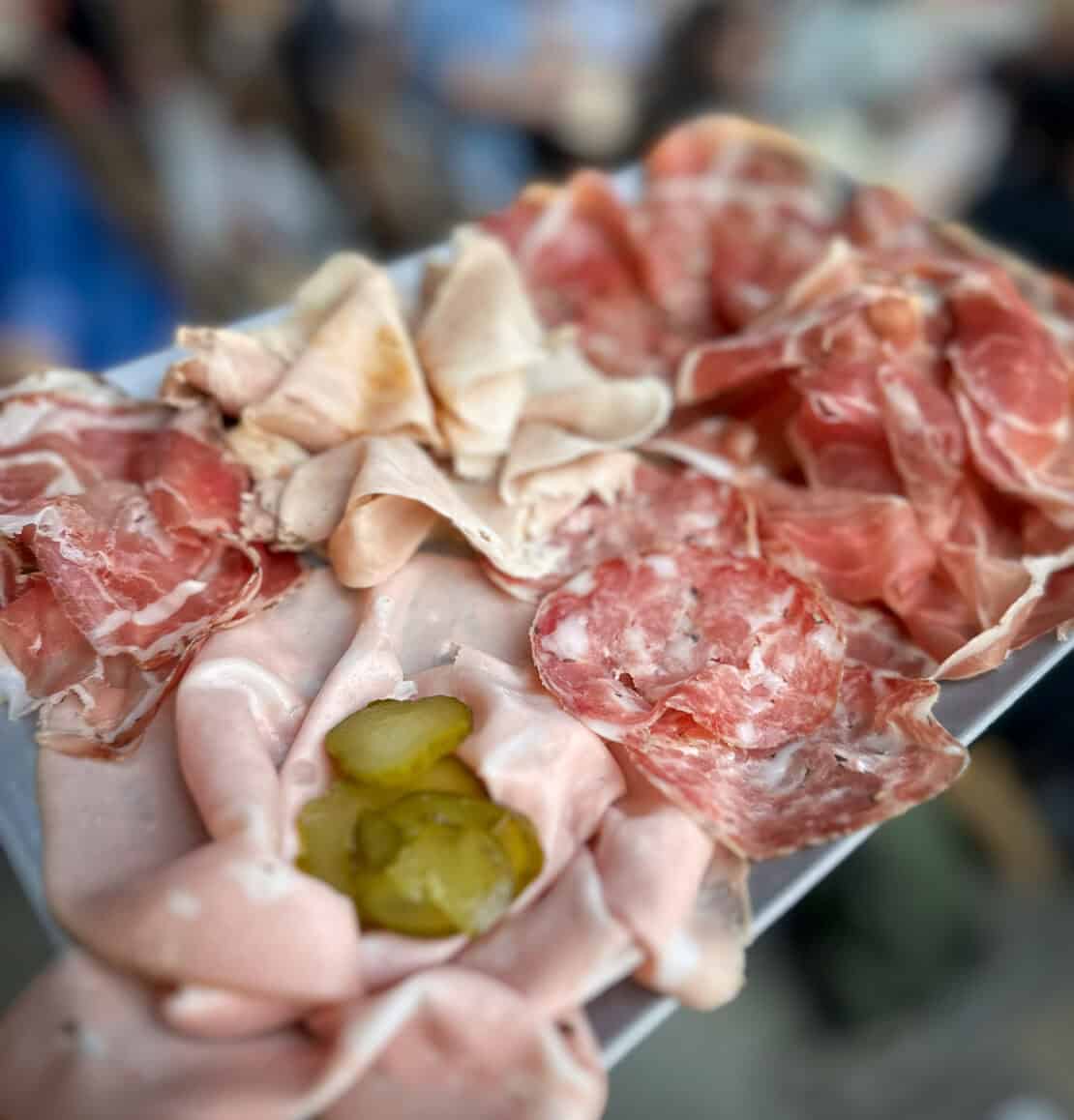 Platter of Italian cured meats and salumi served in a Venetian bacaro in Venice, Italy