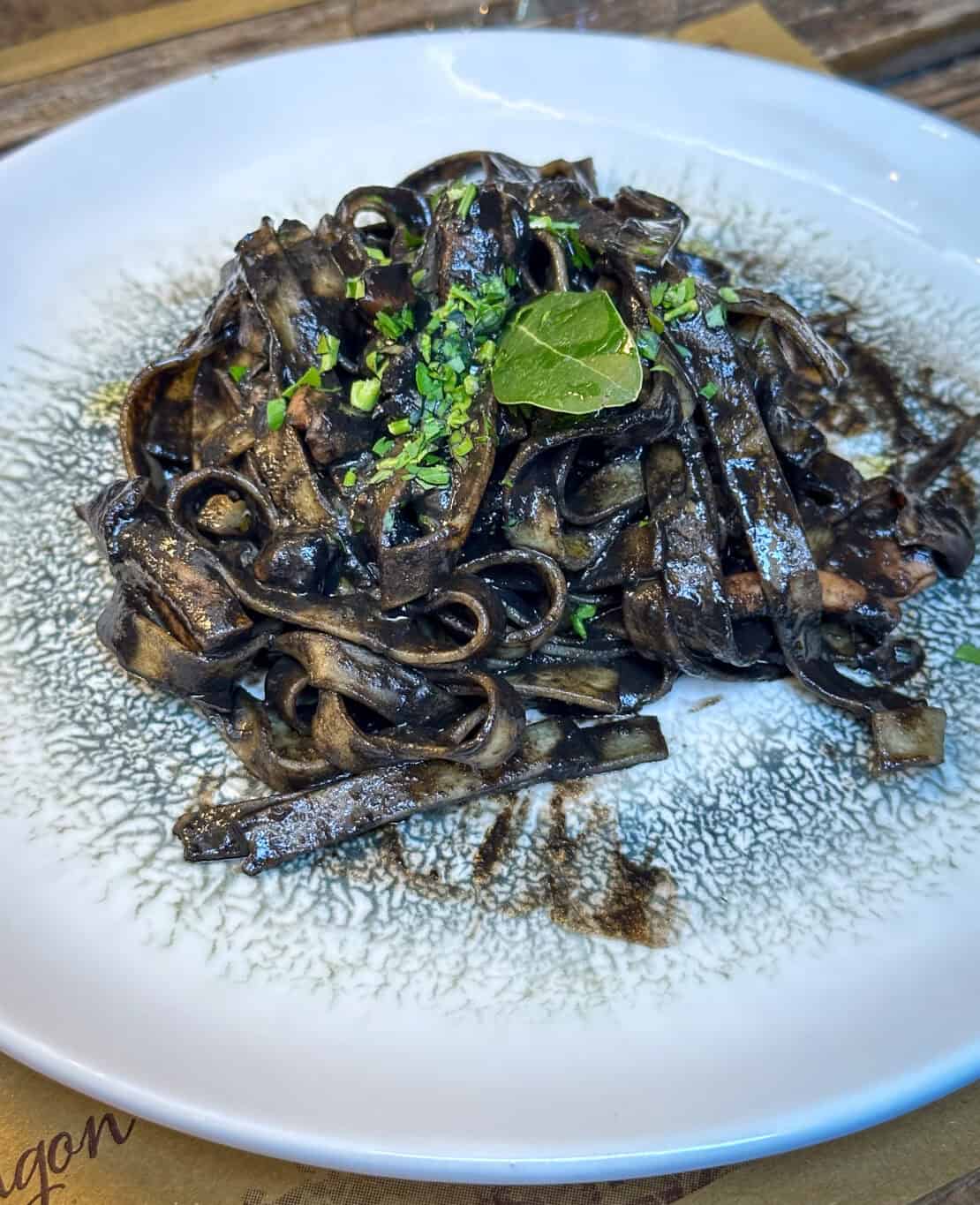 Squid ink tagliatelle served in a restaurant in Venice, Italy