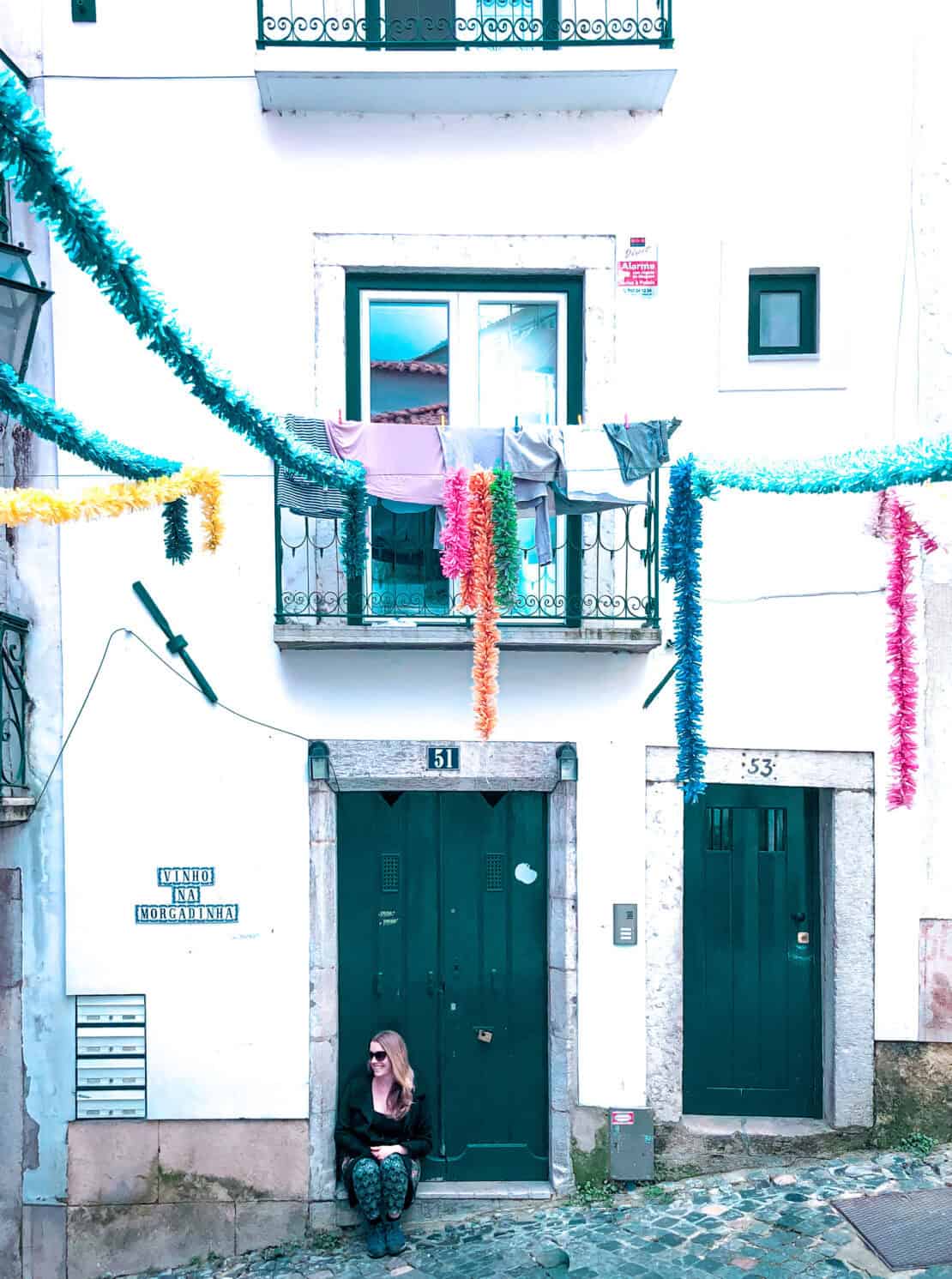 Abigail King in Lisbon with ceramic road sign Portugal