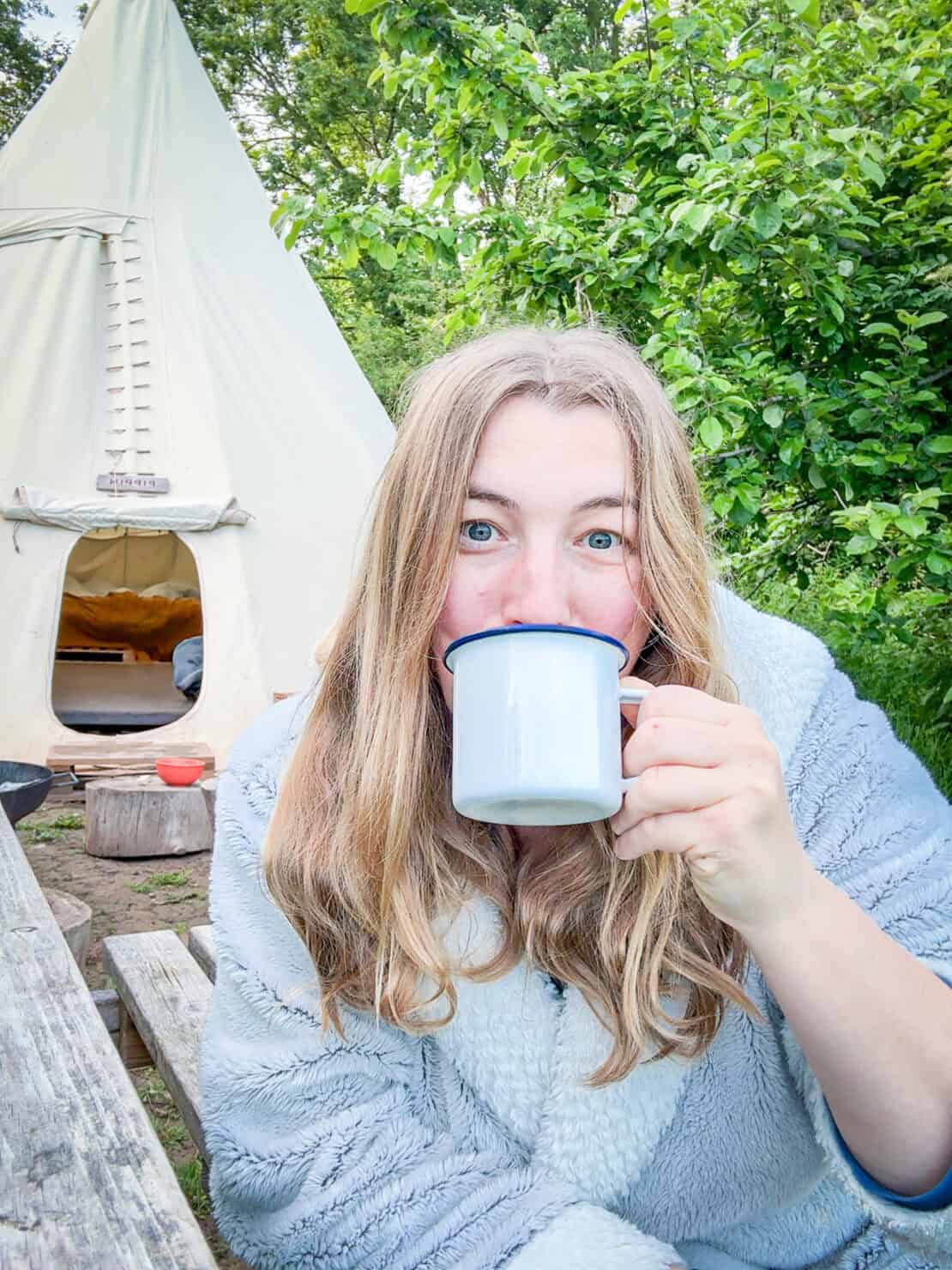 Abigail King with coffee cup glamping White House Glamping Herefordshire England