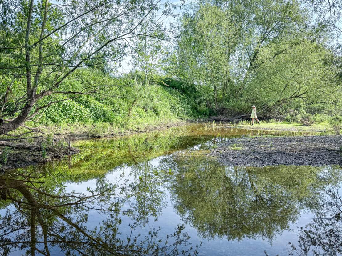 Child playing near river at White House Glamping Herefordshire England