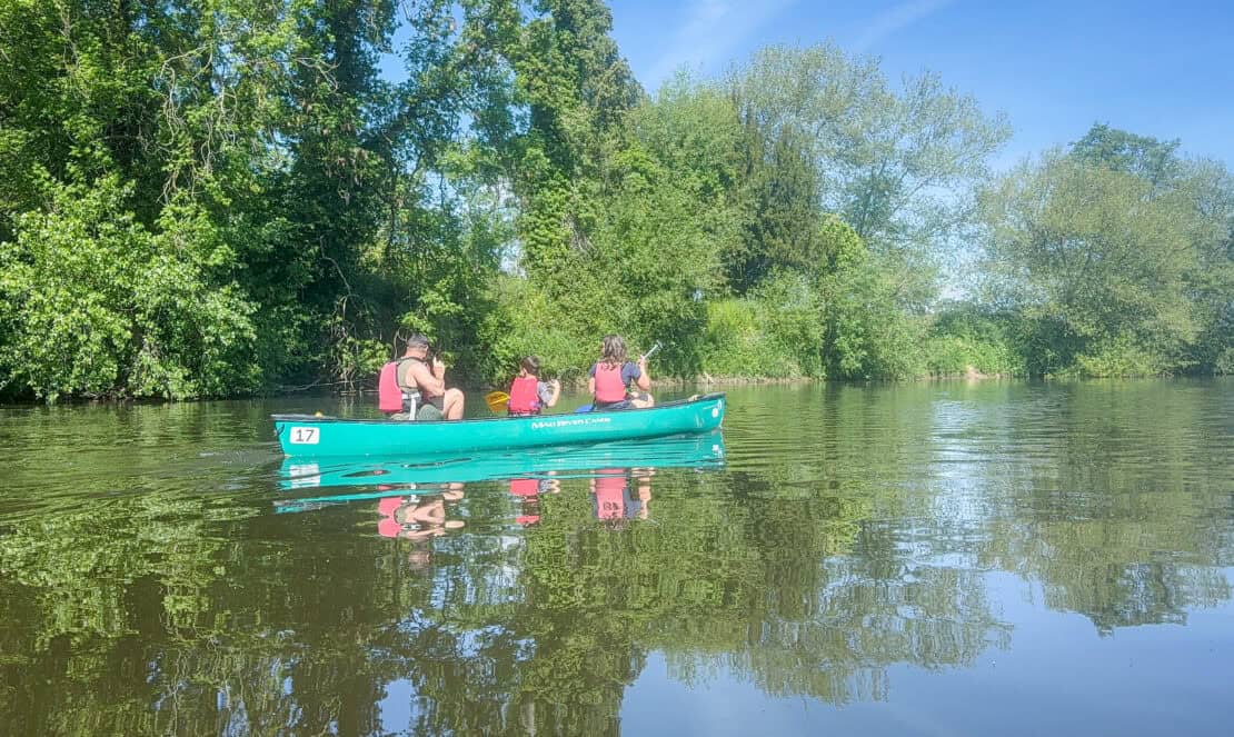 Family canoeing on the River Wye in Herefordshire