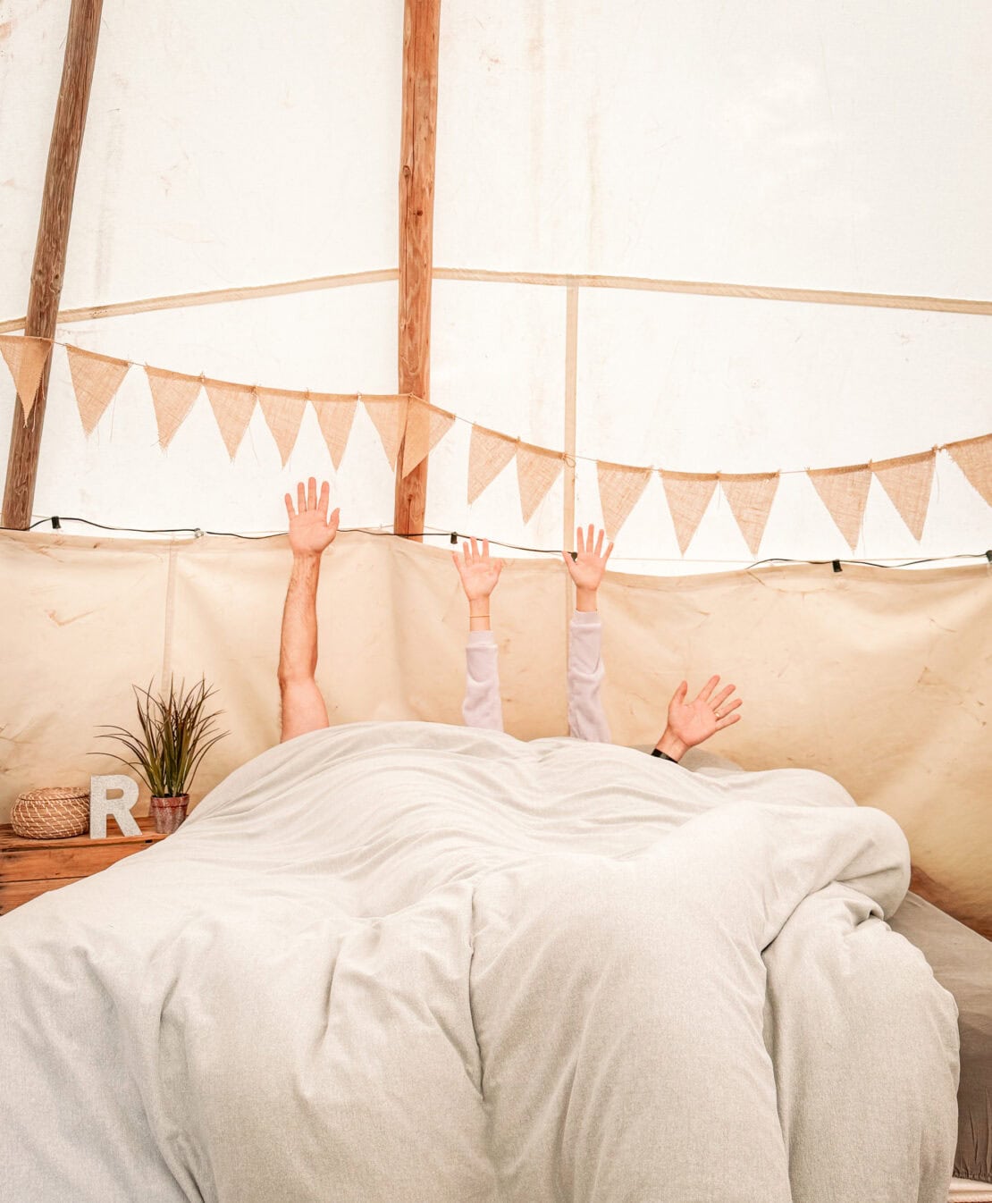 Family relaxing inside a tipi at White House Glamping in Herefordshire