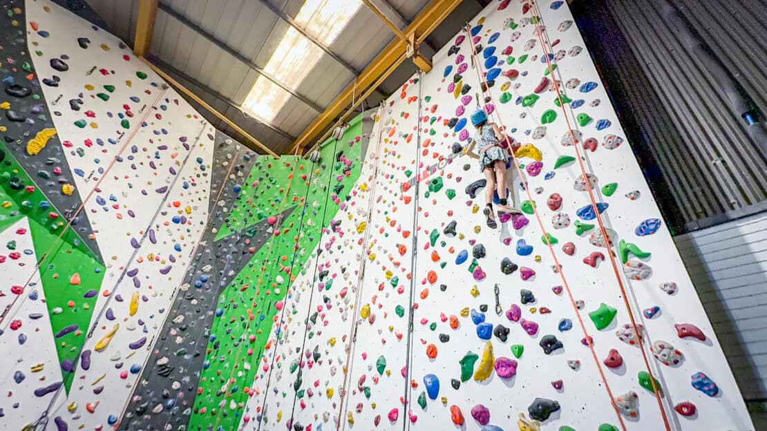 Girl climbing an indoor wall at Green Spider Climbing Centre in Hereford
