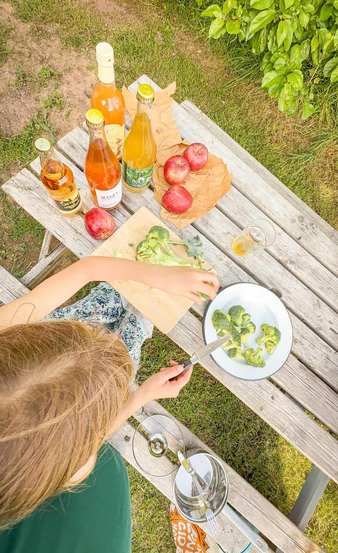 Girl preparing food glamping at White House Herefordshire England