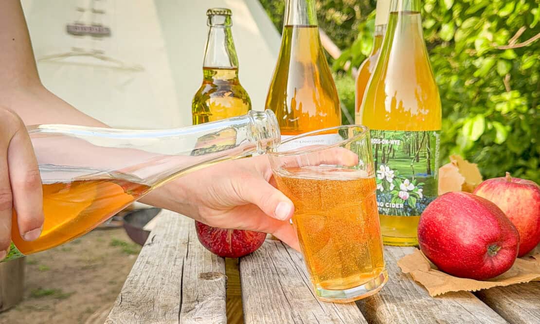 Bottles of Ross-on-Wye cider displayed with local apples in Herefordshire