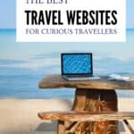 Laptop on a wooden table overlooking a calm beach, representing online travel planning and travel inspiration