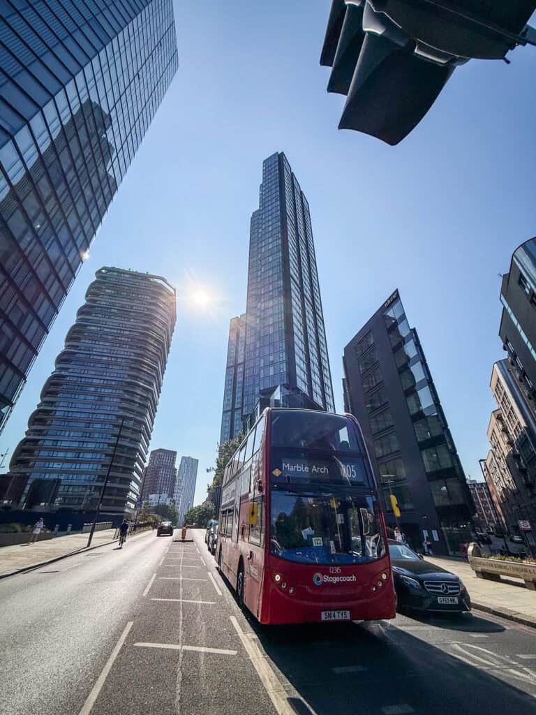 London bus surrounded by skyscrapers near Old Street