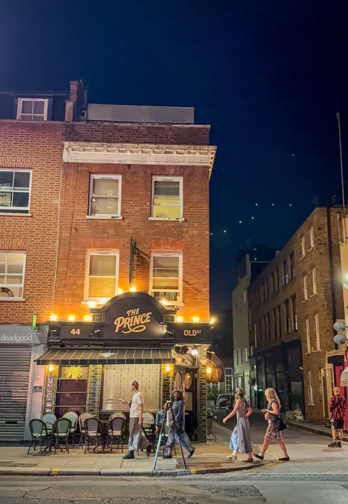People walking past the Prince pub in London, England
