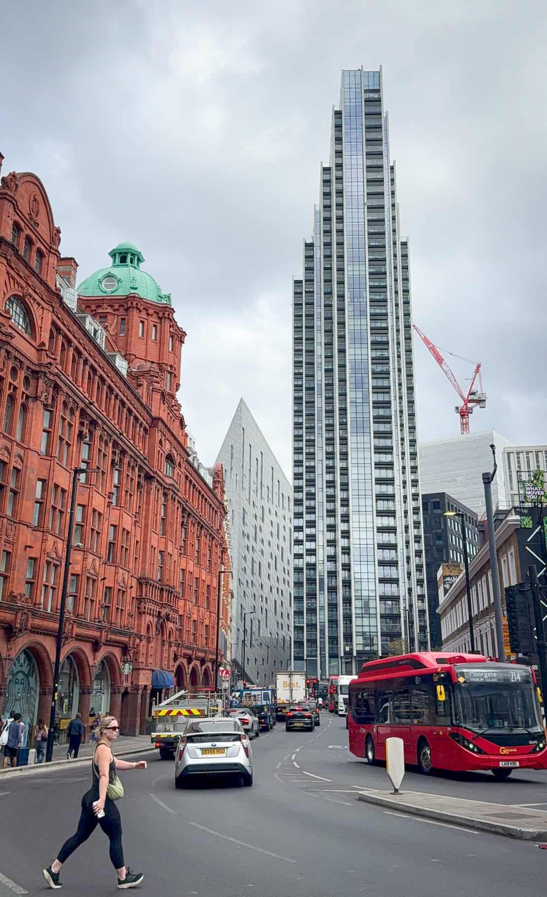View from Old Street with red bus and woman striding in London