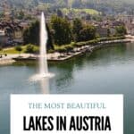 View across Lake Lucerne in Switzerland with a fountain in the water, a tree-lined waterfront and green hills beyond